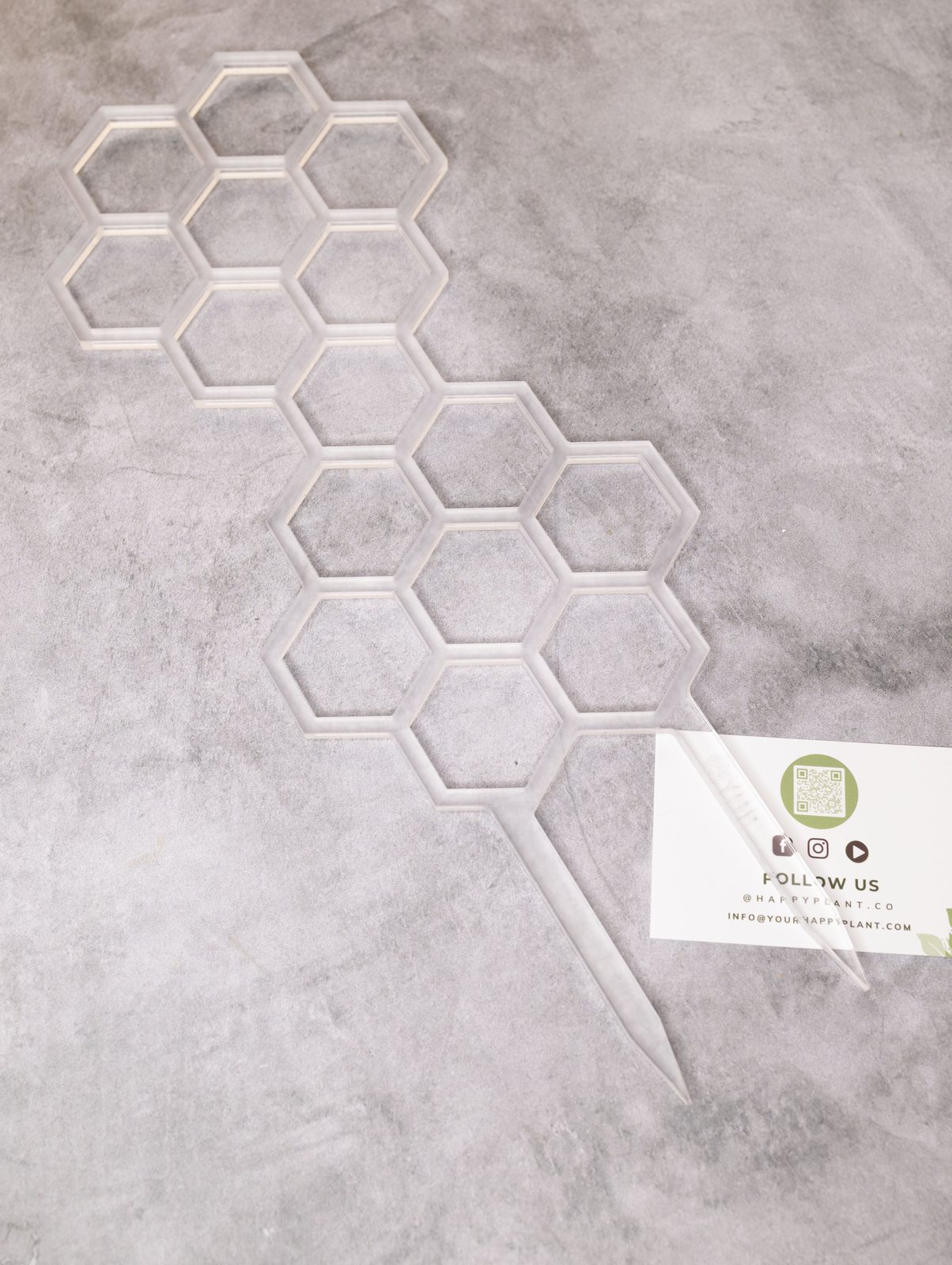 A clear honeycomb trellis on a stake