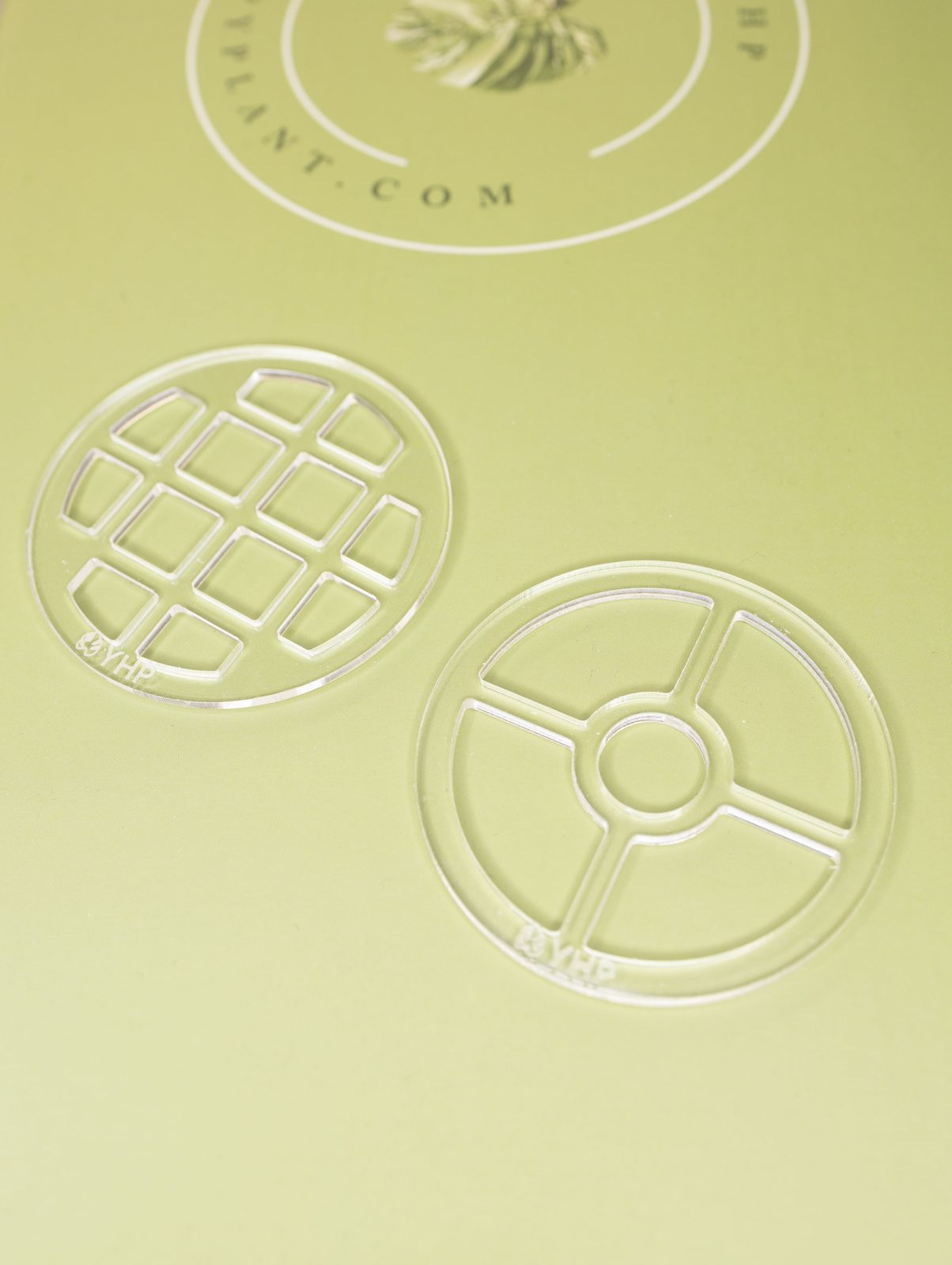 Two clear round propagation inserts stamped with the YHP logo